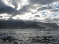 Sky through the clouds over rough water